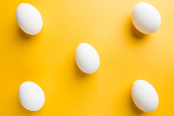 Set of white eggs on the yellow background in center. Pop art design minimalism style