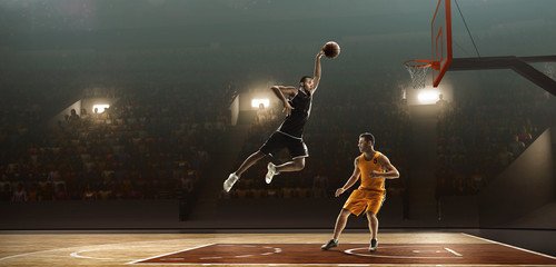 Two basketball players fight for ball on court. Slam dunk - obrazy, fototapety, plakaty
