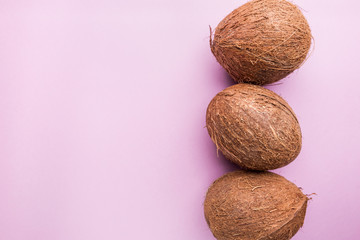 Pattern with ripe coconuts on pink background. Top View, copy Space, flat lay Pop art design, creative summer concept. Banner.