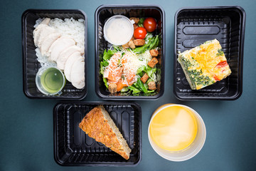 Healthy food delivery. Take away food for diet. Fitness nutrition, balanced proteins, fats and carbohydrates in plastic boxes. Top view, flat lay.