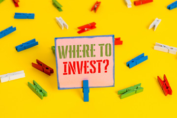 Word writing text Where To Invest Question. Business photo showcasing asking about where put money into financial schemes or shares Colored clothespin papers empty reminder yellow floor background