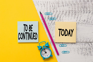 Word writing text To Be Continued. Business photo showcasing indicate that the story continues in the next episode Notepads marker pen colored paper sheet alarm clock wooden background