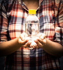 Woman holding a plastic bottle of water