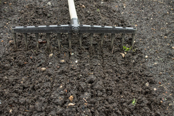 Loosening the excavated ground with a rake close-up