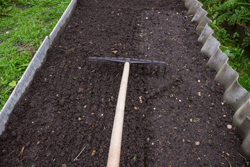 Loosening the excavated ground with a rake close-up