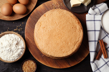 Flat lay composition with delicious fresh homemade cake on black wooden table