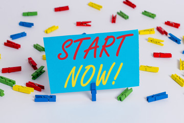 Text sign showing Start Now. Business photo text do not hesitate get working or doing stuff right away Colored clothespin papers empty reminder white floor background office