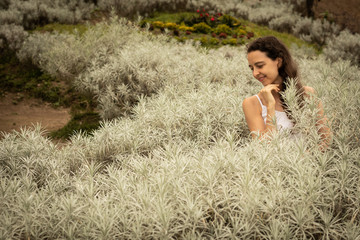 Portrait of Caucasian woman in edelweiss garden. Edelweiss valley in Bali.