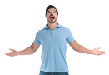 Naklejka premium Happy young man with hands up on white background