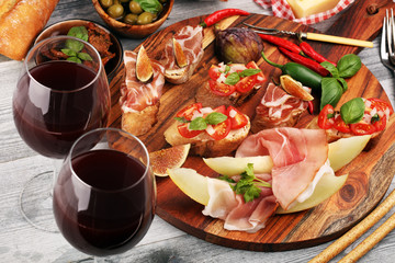 Italian antipasti wine snacks set. Cheese variety, Mediterranean olives, Prosciutto di Parma,...