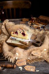 homemade tasty biscuit cake with cherries, almond flakes, powdered sugar on top