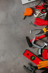 Flat lay composition with repair tools on grey stone table, space for text