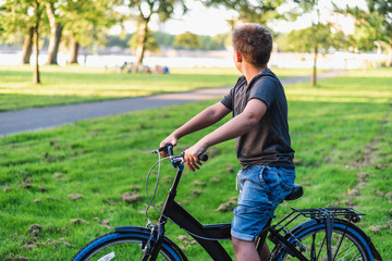 Naklejka premium Boy riding a bicycle in the park.