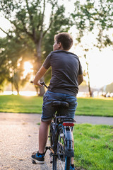 Boy riding a bicycle in the park.