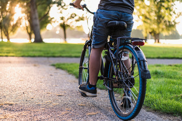 Naklejka premium Boy riding a bicycle in the park.