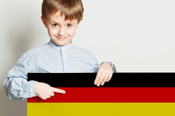 Happy child boy holding the Deutsch flag on white background