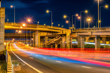 Fototapeta na wymiar Underside of an elevated roads Expressway bridge and traffic at night
