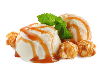 Scoops of delicious ice cream with caramel sauce, mint and popcorn on white background