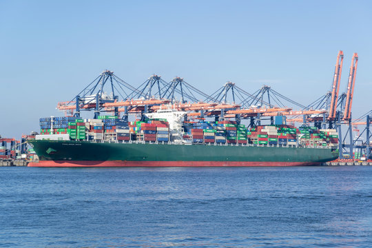 MAASVLAKTE, THE NETHERLANDS - JULY 5, 2019: THALLASA DOXA moored at the Euromax Terminal. THALLASA DOXA is a Thalassa-Hellas class ULCS container ship with a capacity of 13.800 TEU.