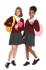 Happy girls in school uniform on white background