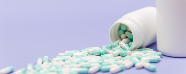 Pills spilling out of pill bottle. Pharmaceutical industry. Pharmacy.
