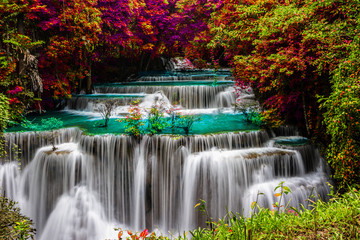 Fototapeta na wymiar amazing of huay mae kamin waterfall in colorful autumn forest at Kanchanaburi, thailand