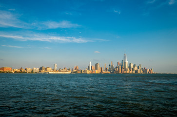 Golden sunset view of the Downtown Manhattan New York City skyline from across the Hudson River in...