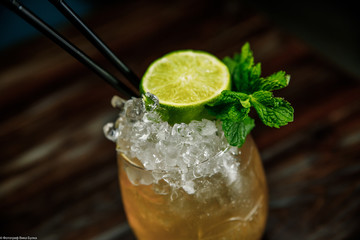 Fresh Mojito cocktail with lime, rosemary, mint and ice in jar glass on. Summer cold drink and cocktail