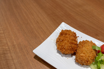 Japanese Crunchy Fried, Hokkaido Pumpkin Croquette on plate in restaurant.