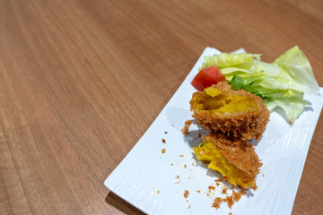 Japanese Crunchy Fried, Hokkaido Pumpkin Croquette on plate in restaurant.