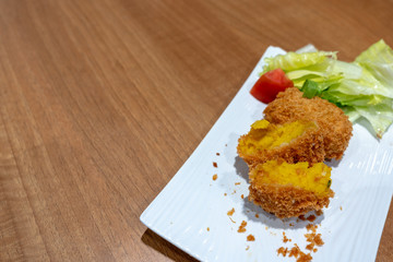 Japanese Crunchy Fried, Hokkaido Pumpkin Croquette on plate in restaurant.