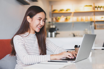 Young Asian woman using laptop internet for working and job finding
