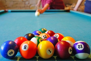 Playing billiard pool game with colorful balls