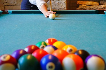 Playing billiard pool game with colorful balls