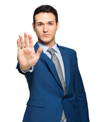 Young businessman making the stop sign with his hand