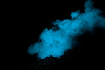 Blue powder explode cloud on black background. Launchedblue dust particles splash on  background.