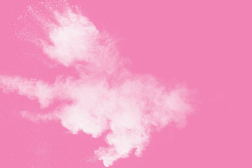 Fototapeta na wymiar White powder explosion on pink background.White dust particle splashing.