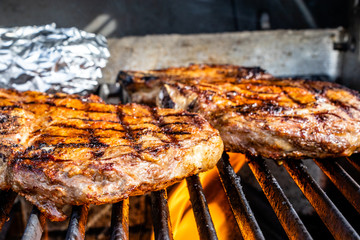 Fire licking the steaks on the grill. Calgary, Alberta, Canada