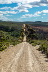 Long straight gravel road through the valley