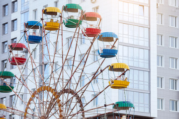 Carousel ferris wheel in a summer city park.