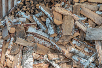 Stacks of firewood for next winter. Pile of firewood. Firewood background