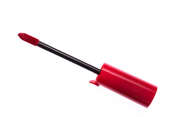 Red color lip gloss brush on background
