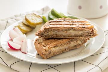 Homemade toast sandwich with vegetables on kitchen table.