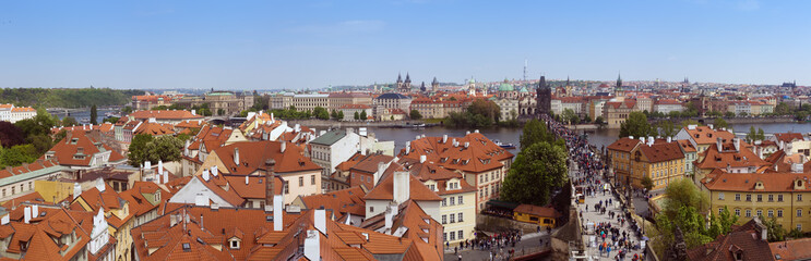 Fototapeta na wymiar Beautiful panorama of Charles bridge (Karluv Most), Vltava river and red roofs from the Bridge Tower