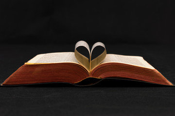 open Bible with sides formed into a heart