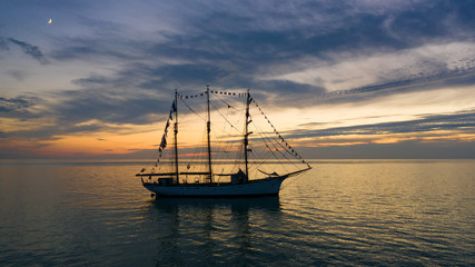 Fototapeta premium Le Marité aux Grandes Dalles, un bateau à voiles en Normandie sur la mer au crépuscule