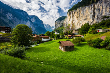 Famous view of Lauterbrunnen town in Swiss Alps valley with gorgeous Staubbach waterfalls in,...