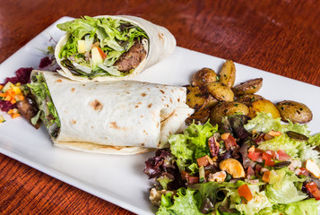 delicious beef kabab with fresh salad and grilled garlic.