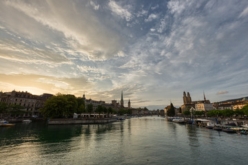 Fototapeta premium Historic Zurich downtown skyline with Fraumunster and Grossmunster churches at lake zurich during sunset, Switzerland