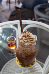 Iced mocha coffee with whip cream topping and syrup